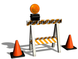 Road barrier with flashing light. Sign says 'under construction'
